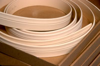 Flexible moulding coiled in a box for shipping